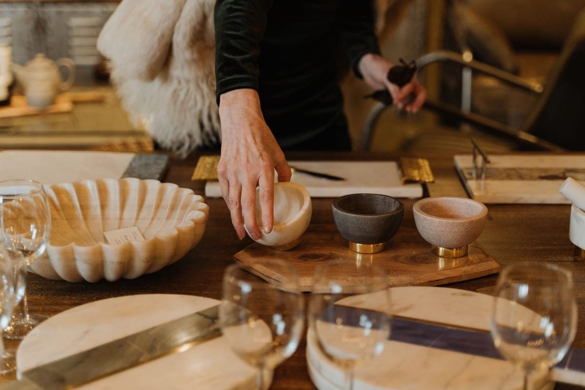 A person choosing between two objects on a table
