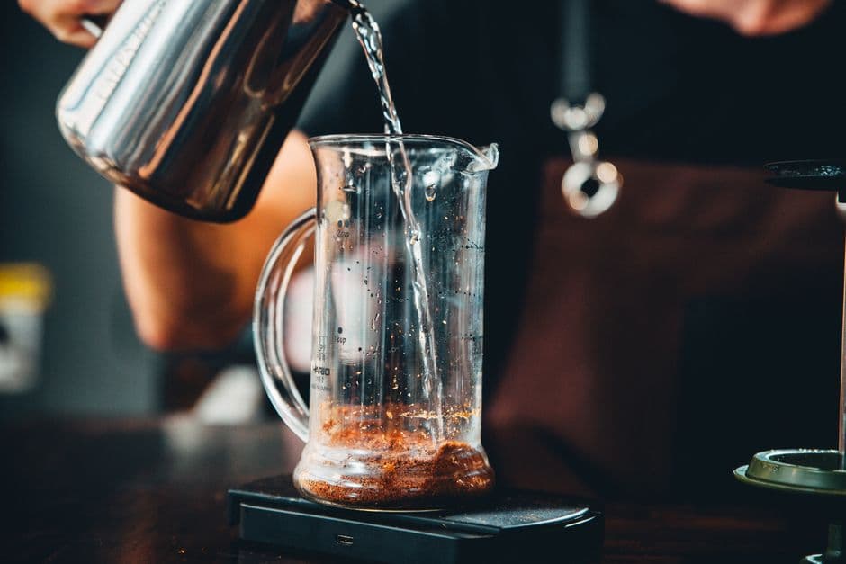 Hot water being poured into a glass jug