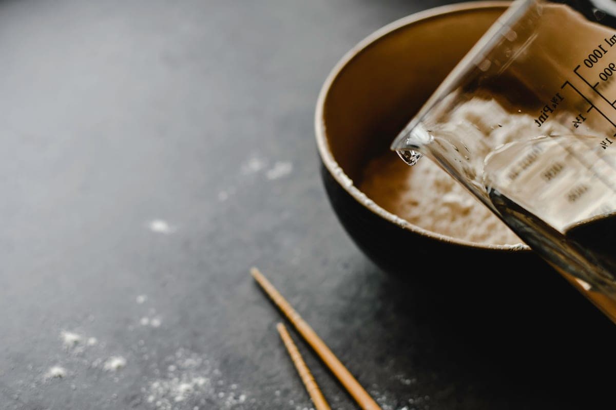 A measuring cup with water on a kitchen counter